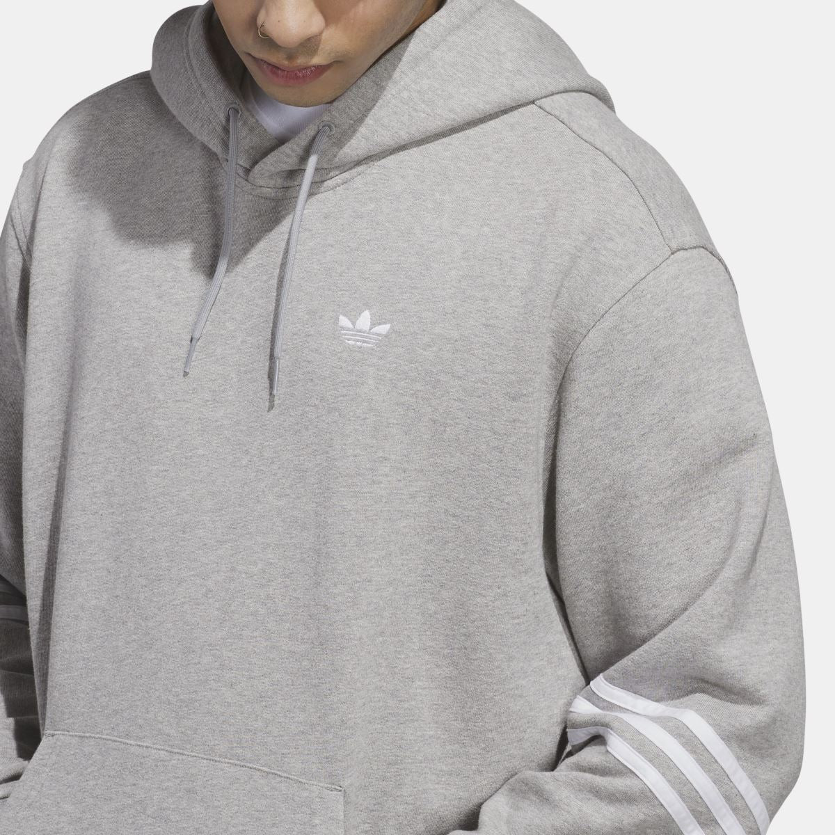 Grey hoodie close-up showing chest logo and drawstring hood.