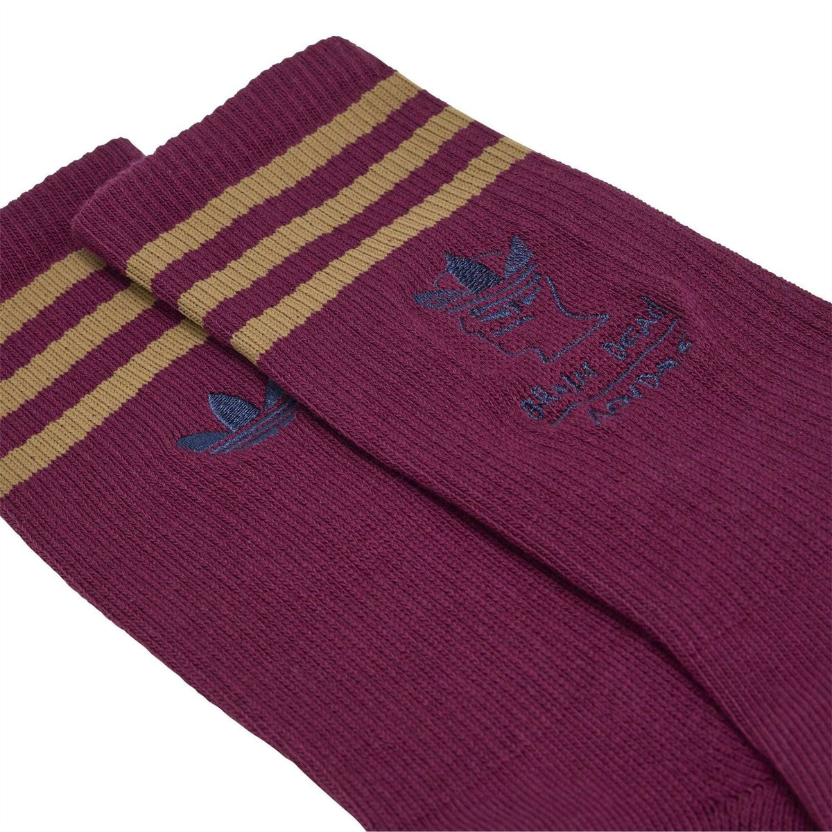 Folded pair of maroon crew socks with beige-and-tan striped cuff and adidas logo