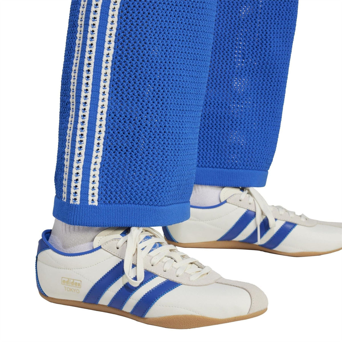 adidas Originals crochet track pants detail: blue fabric with triple white side stripes