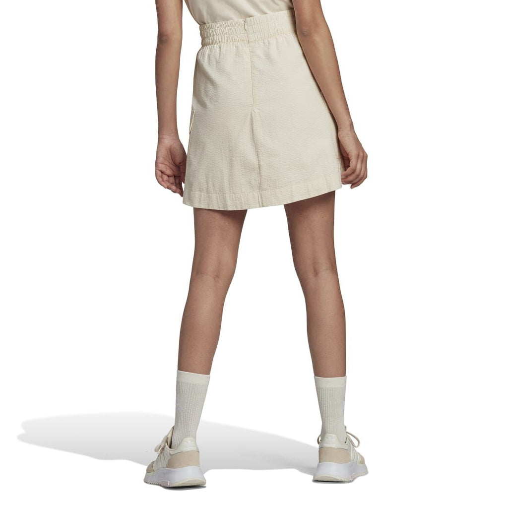 adidas Originals Adicolor Classics poplin skirt with high waist and A-line design, shown in a vibrant color on a model.