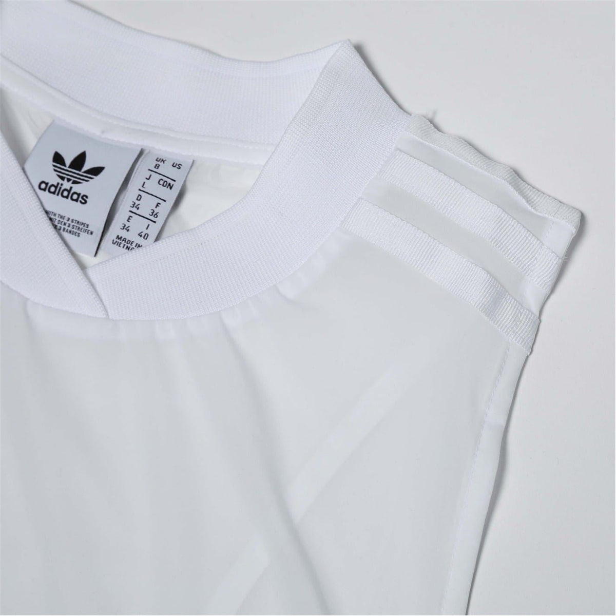 adidas Originals white crew-neck sleeveless dress with adidas label at collar