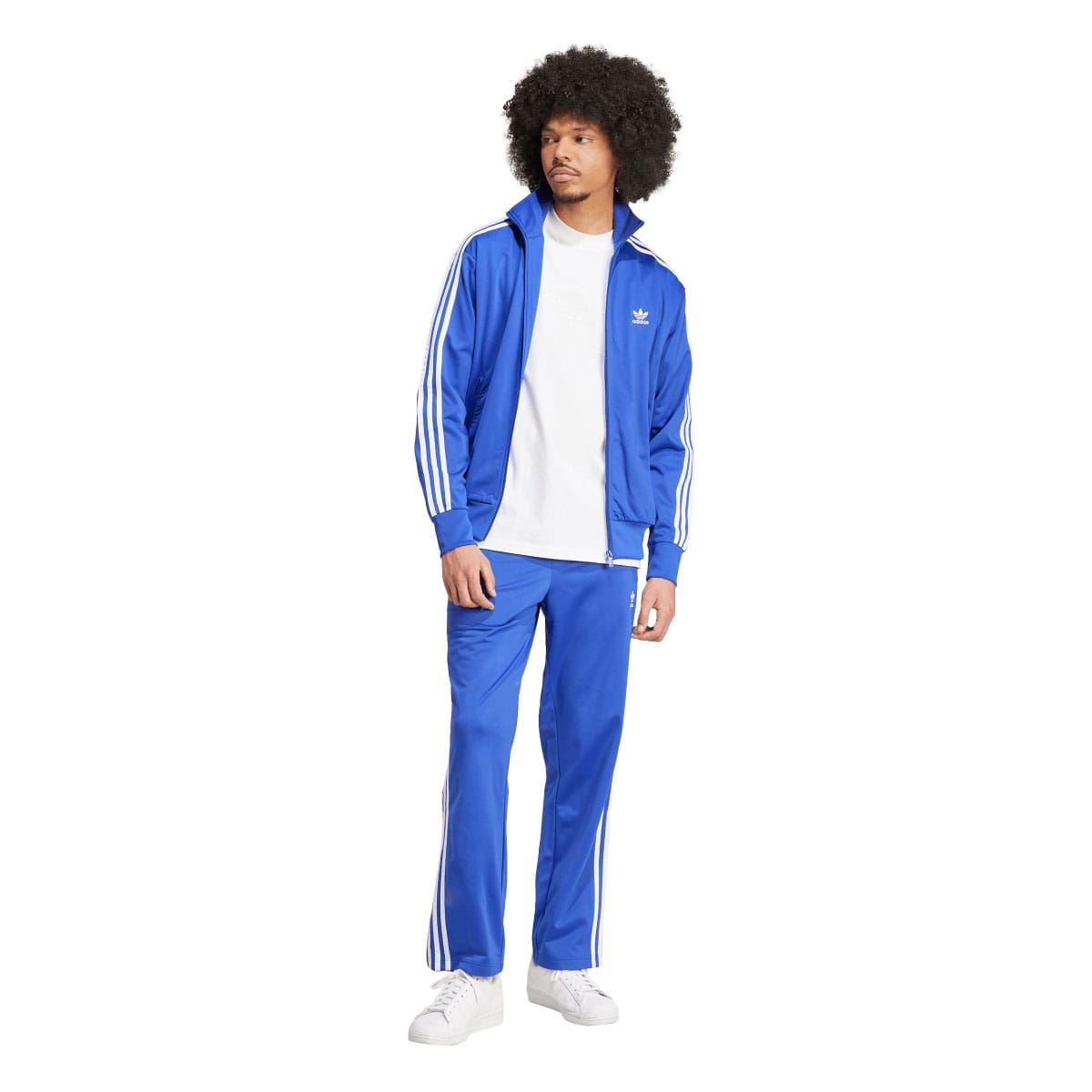Blue adidas track pants with white side stripes and elastic waist