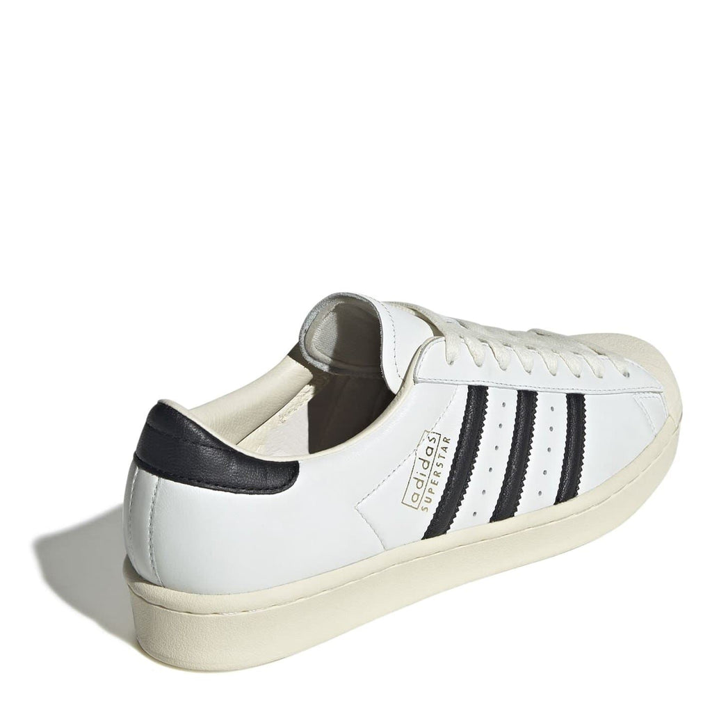 White sneakers with black heel trim, lace-up, beige midsole, back view