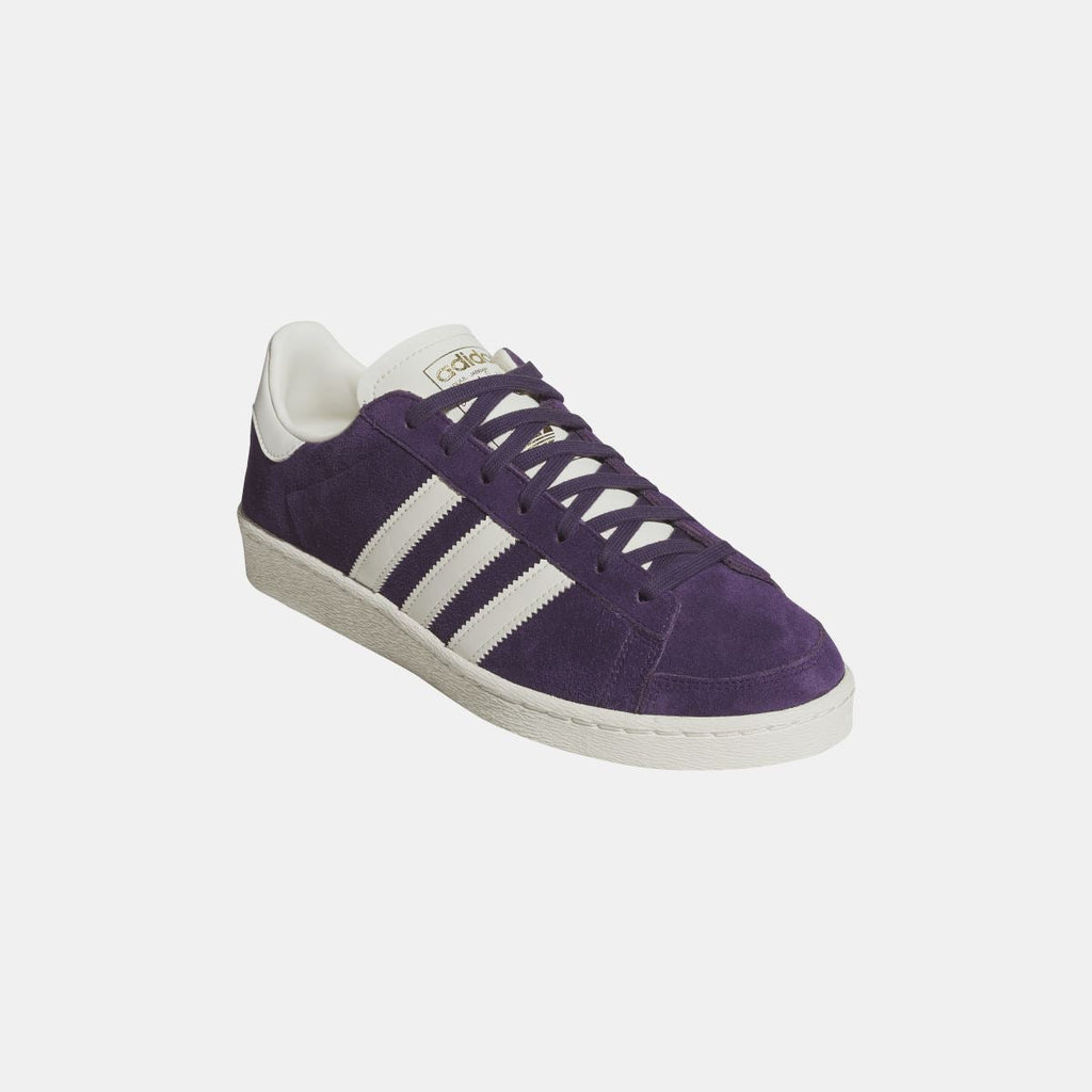 Purple adidas Originals Jabbar Lo sneaker angled side view with white stripes and gray sole