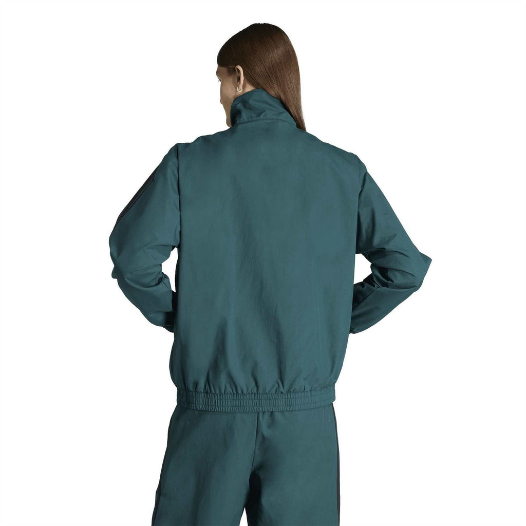 Women’s adidas teal woven track top from back view with ribbed waistband and cuffs
