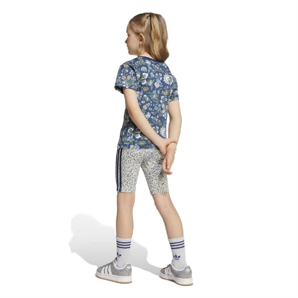 Girls set back view: navy floral T-shirt and white patterned bike shorts
