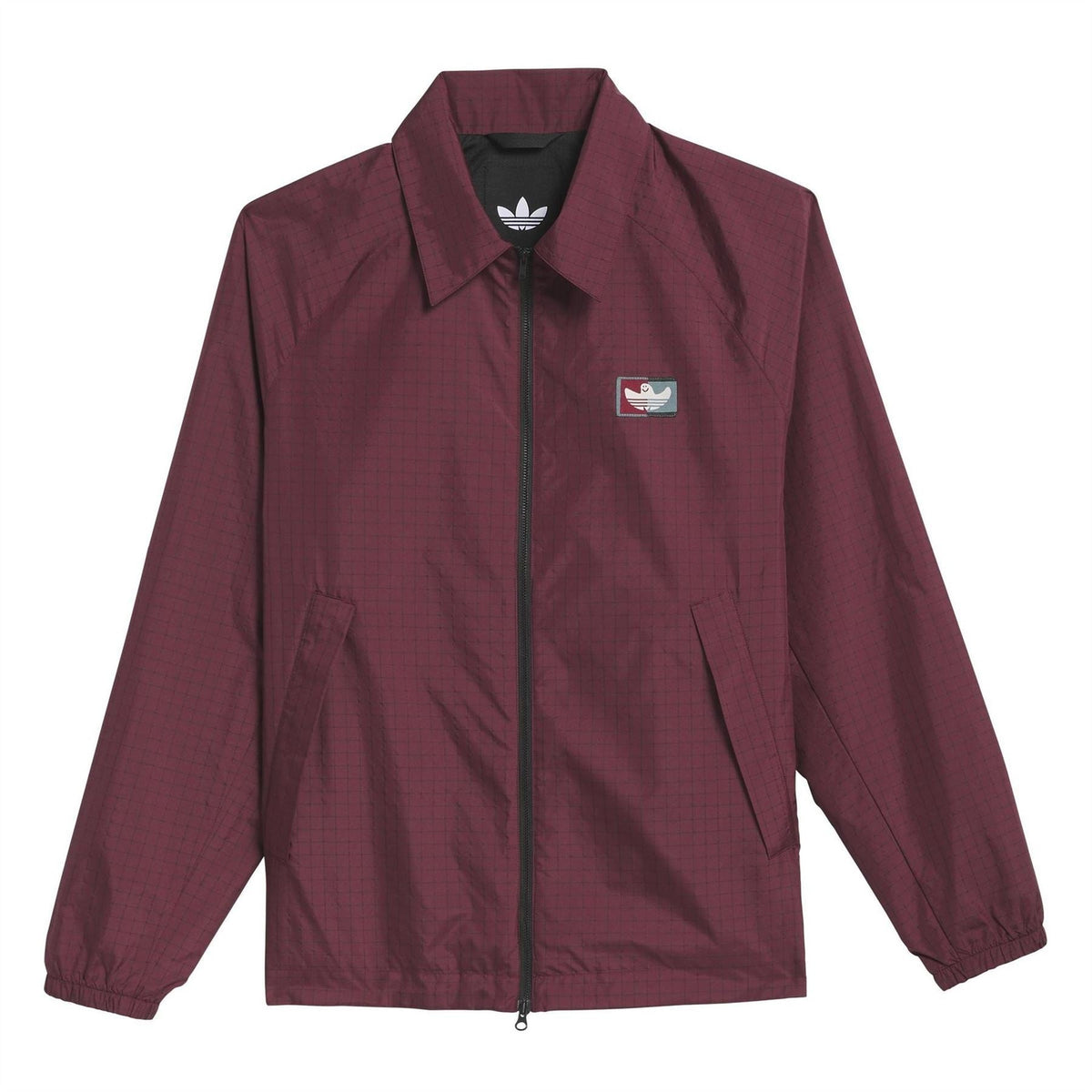 Shadow red coach jacket with full-zip front, stand collar, chest patch logo, side pockets