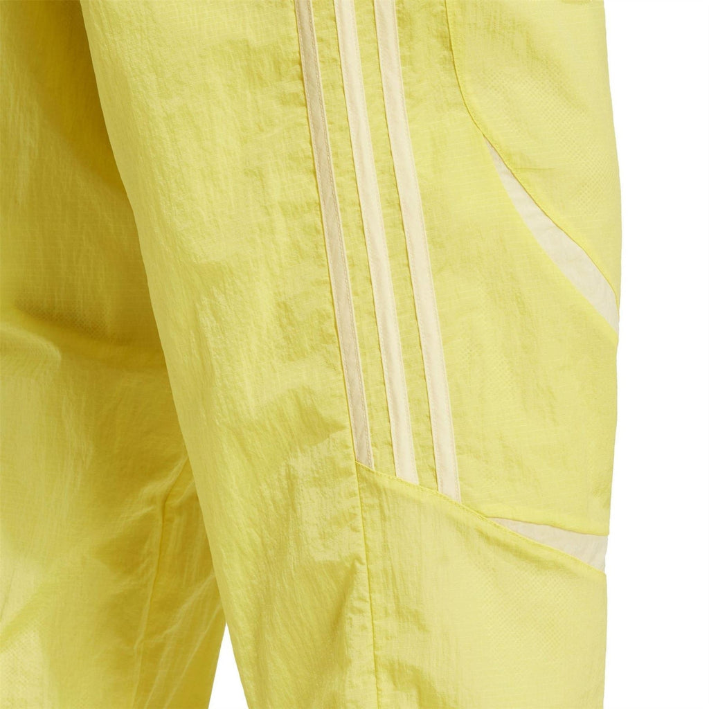 adidas Originals yellow jogger pants close-up of side panel stripes and pocket