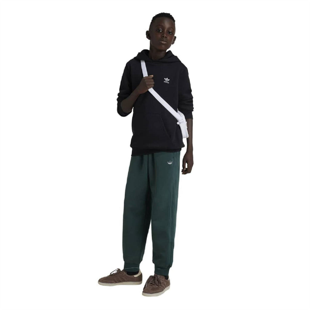 Black juniors pullover hoodie with hood and adidas logo, front view on model