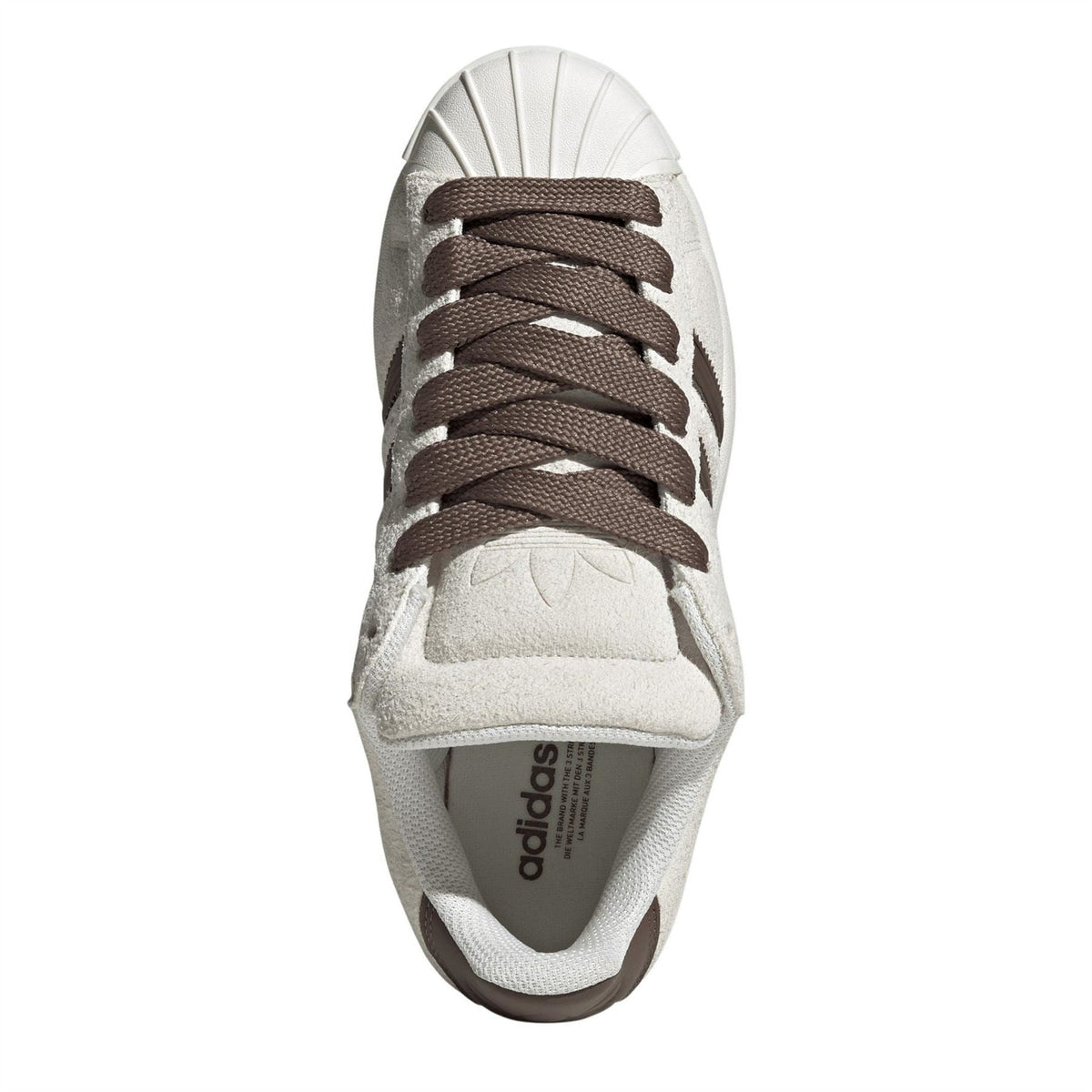 Off-white adidas sneakers with brown laces; adidas branding visible on insole.