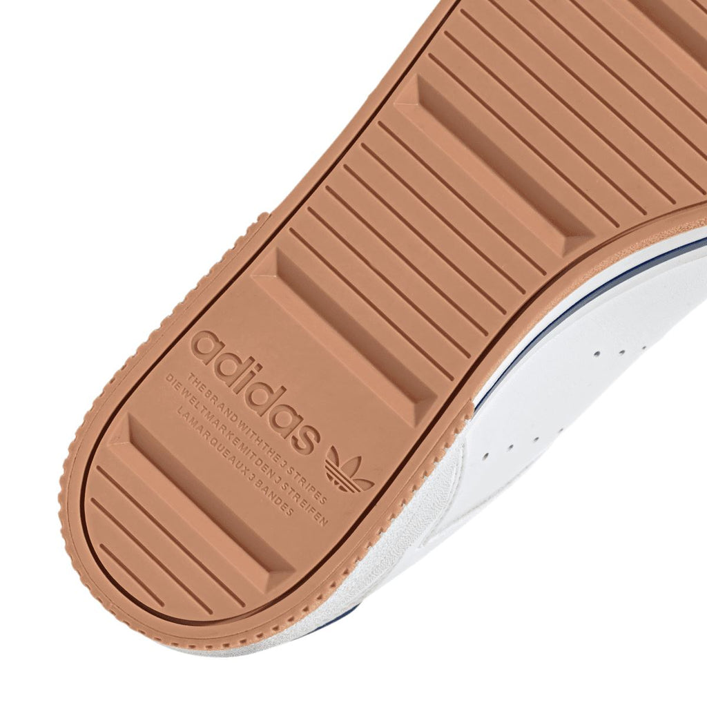 Close-up of brown tread outsole with adidas logo and ridged grip pattern