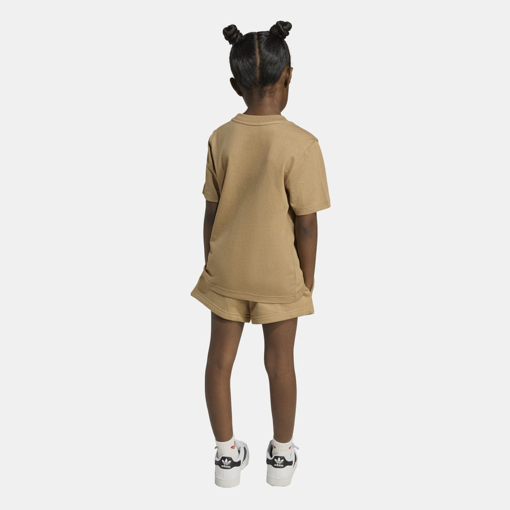 Tan adidas juniors T-shirt and shorts set on model, back view; matching logo on tee