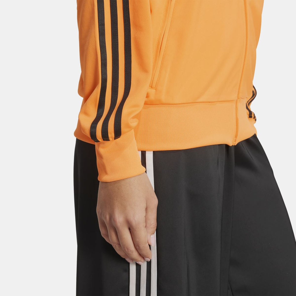 Orange track jacket sleeve with black triple stripes and ribbed hem cuff