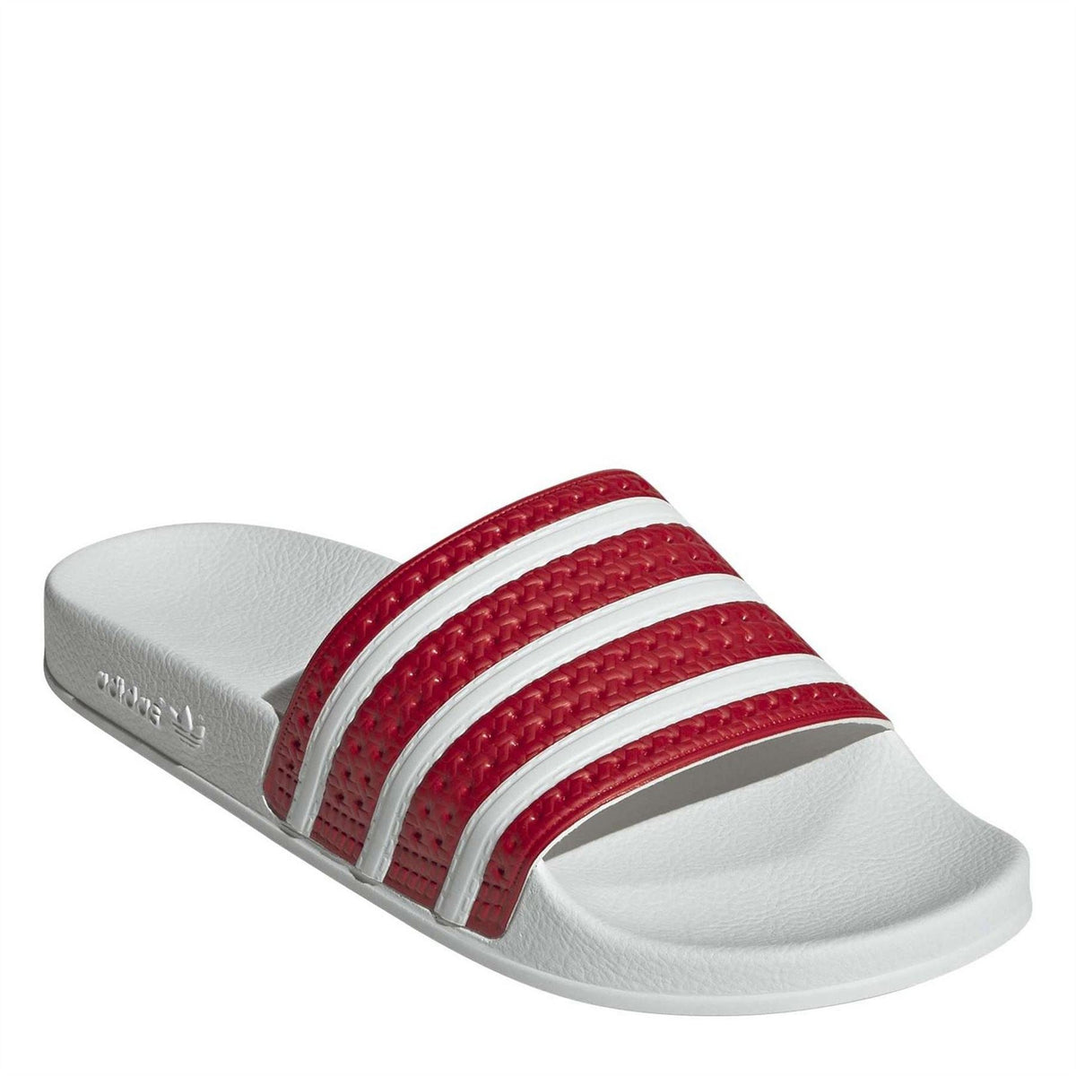 Close-up of red textured adidas Originals slide sandal upper with three white stripes