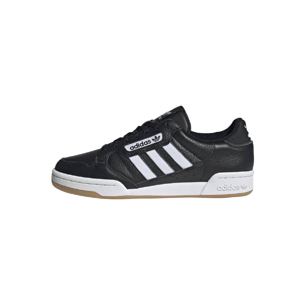 Black adidas low-top trainers with white three stripes and gum-colored sole