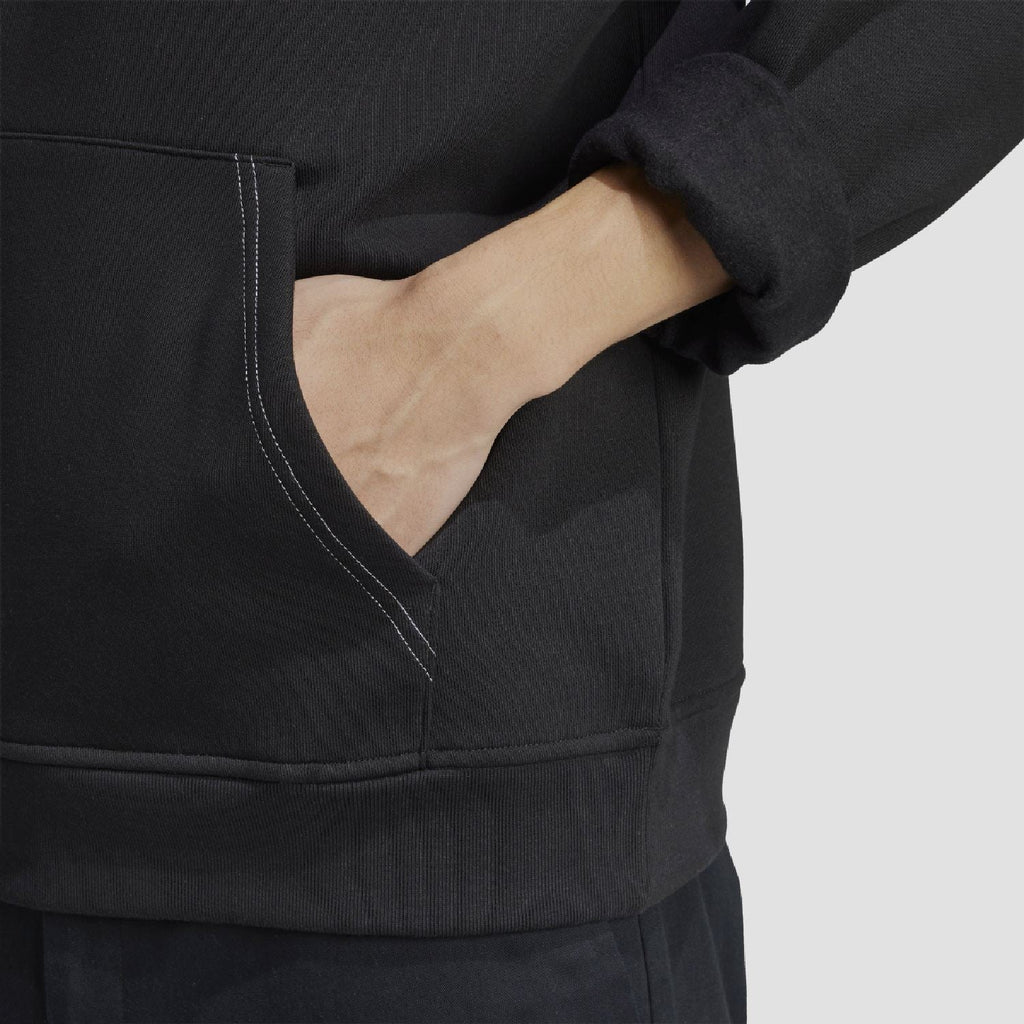 Black hoodie sleeve and kangaroo pocket area with visible stitching detail