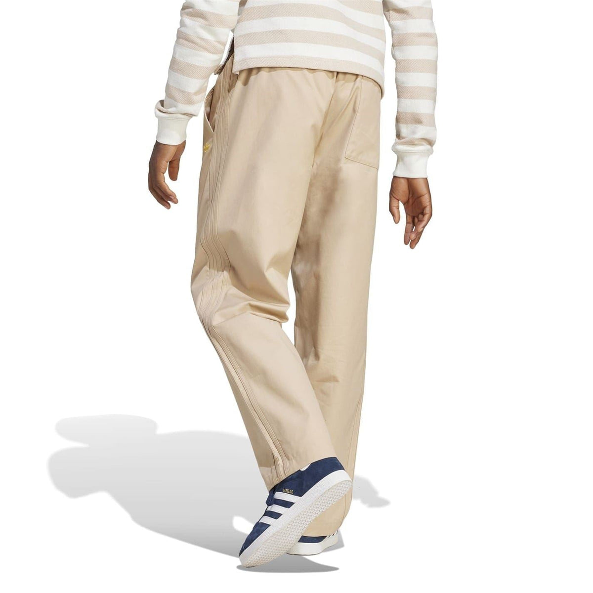 Beige drawstring chinos with gathered waistband and straight leg, side pocket visible