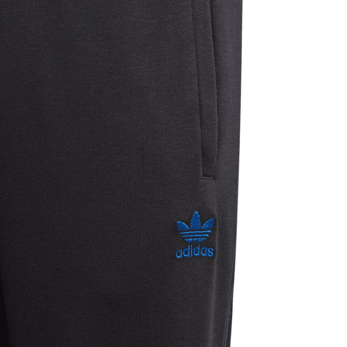 Black adidas Originals logo patch on junior joggers near left thigh