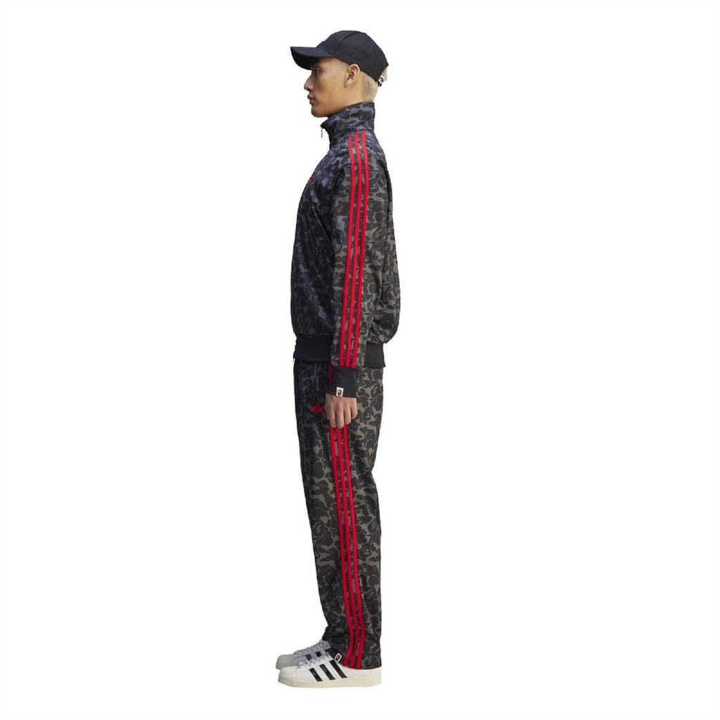 Black camo track pants with red side stripe detail and tapered cuffs