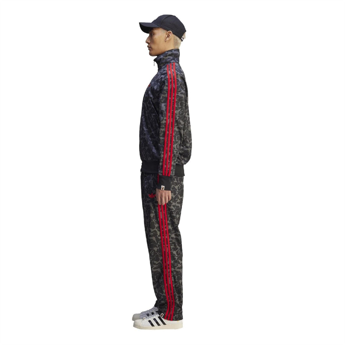 Black camo track pants with red side stripe detail and tapered cuffs