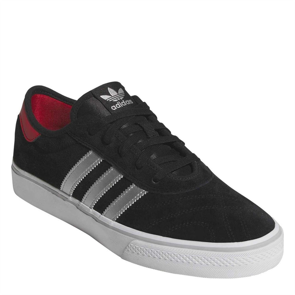 Black adidas suede low-top sneaker, white three stripes, red interior lining, lace-up.