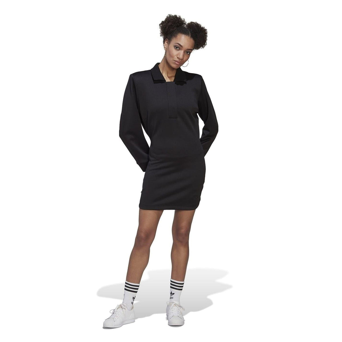 Black long-sleeve mini polo dress, side view with crew collar and fitted silhouette.