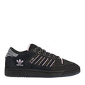 Black low-top trainers with pink accents, three stripe logo, and lace-up front