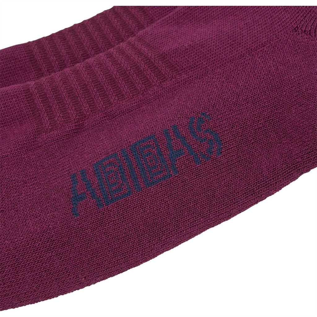 Maroon crew sock close-up with adidas logo and Brain Dead lettering