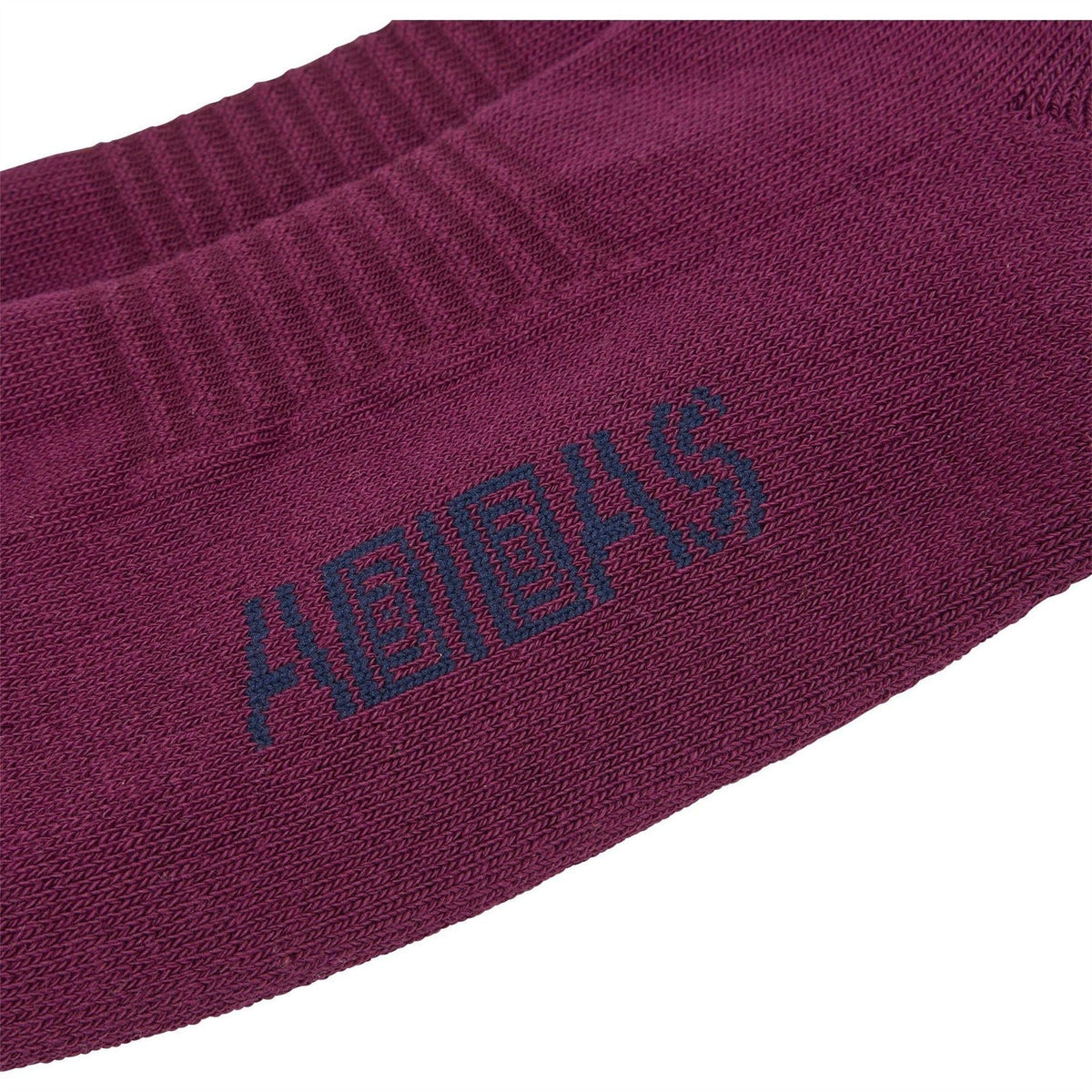 Maroon crew sock close-up with adidas logo and Brain Dead lettering