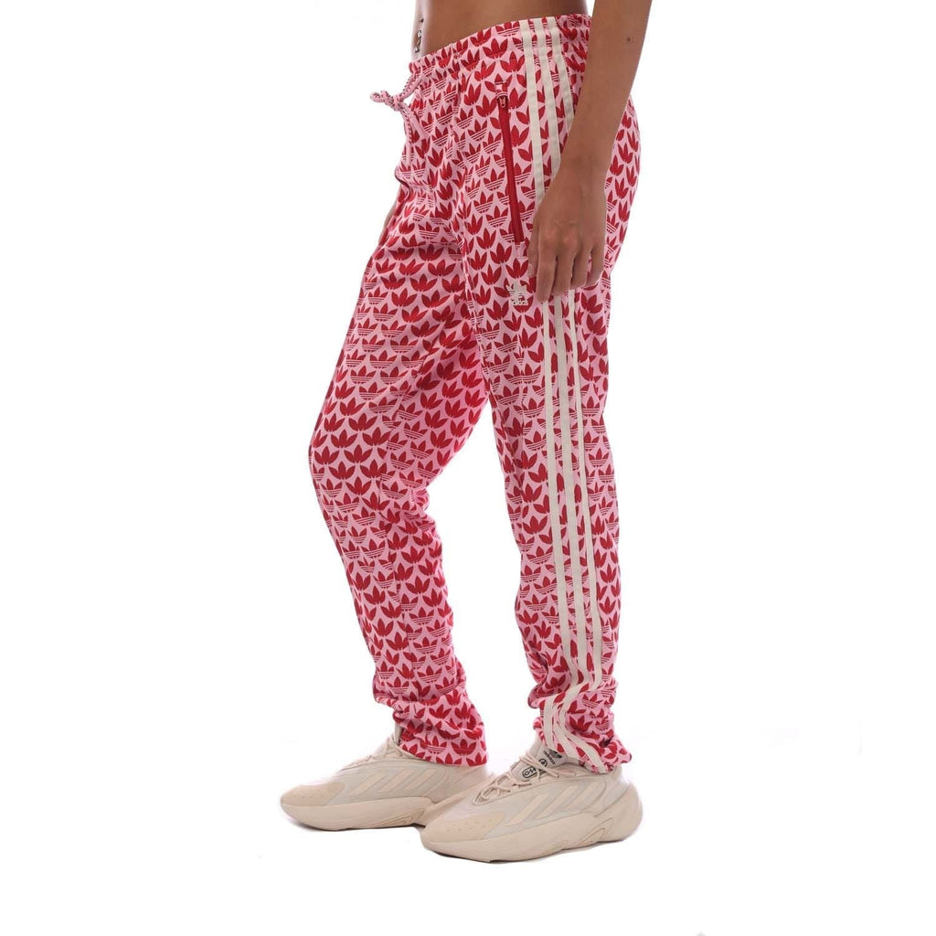 Pink track pants with heart pattern, drawstring elastic waist, side stripe and tapered legs