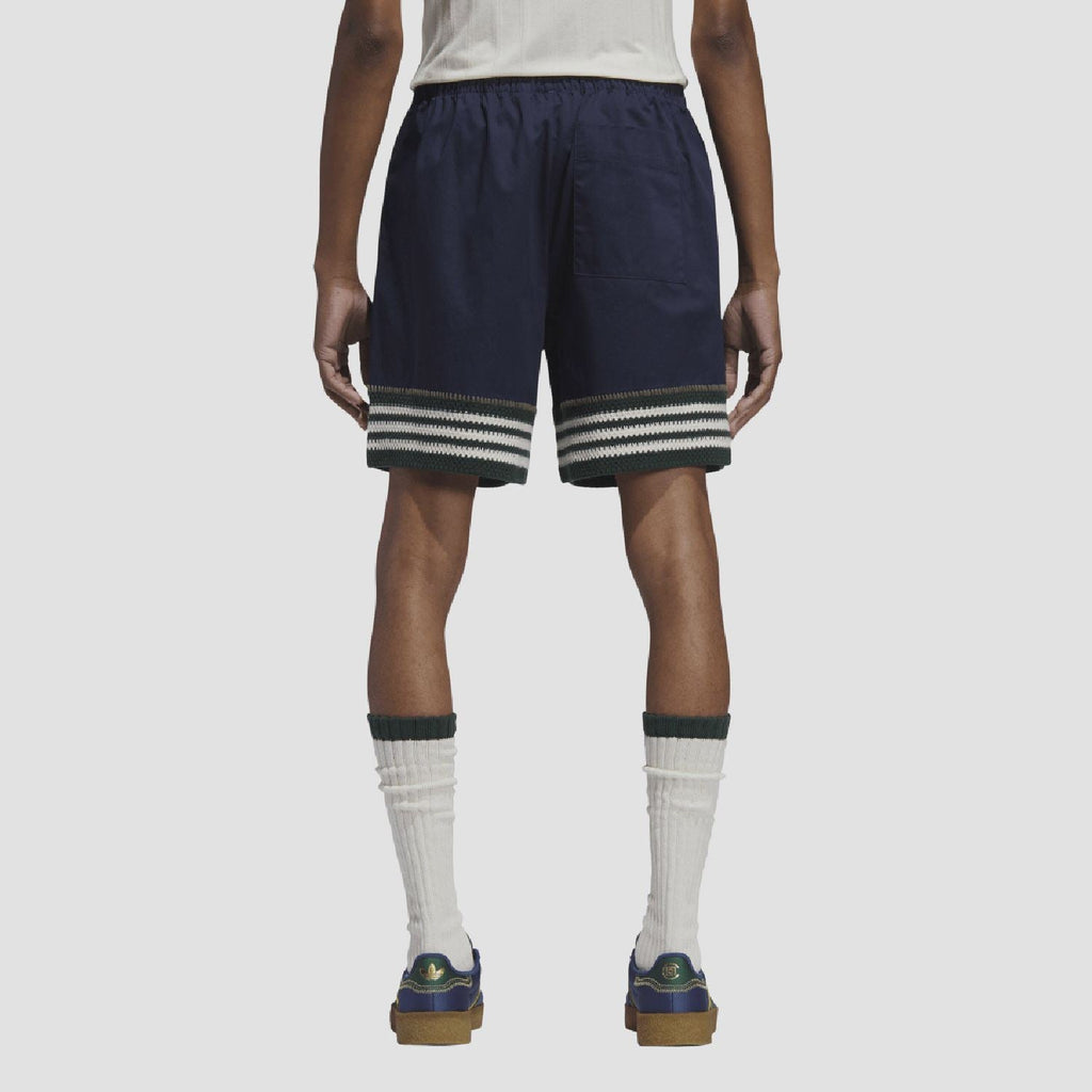 Indigo knit shorts on model, back view with elastic waist and striped hem