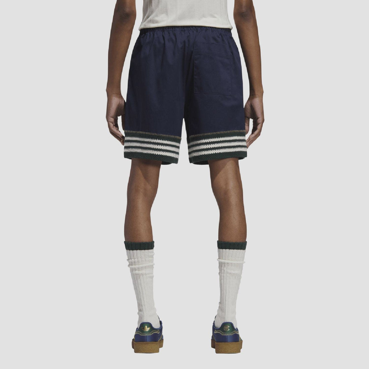 Indigo knit shorts on model, back view with elastic waist and striped hem