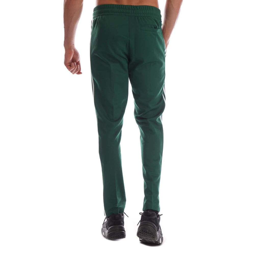 Green track pants with white side stripes, elastic waistband, tapered legs