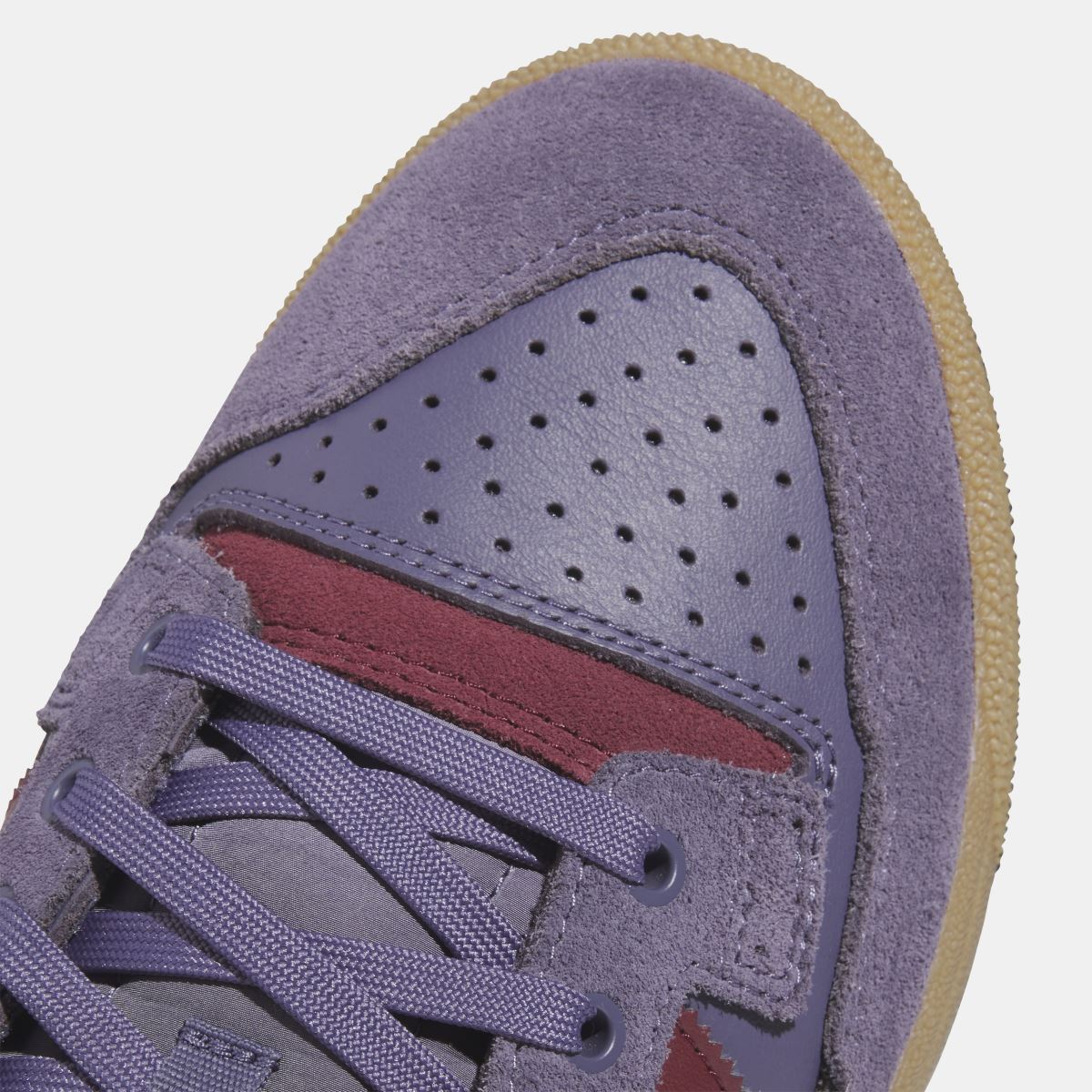 Violet suede adidas Originals low-top toe close-up with perforations and burgundy trim