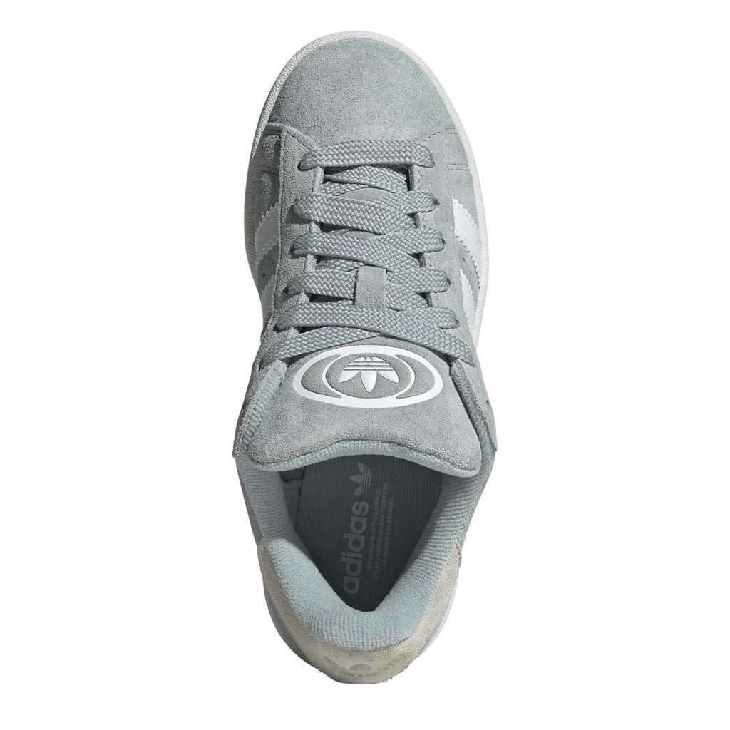 Juniors trainers in light sage suede with white laces and logo detail, cushioned tongue.