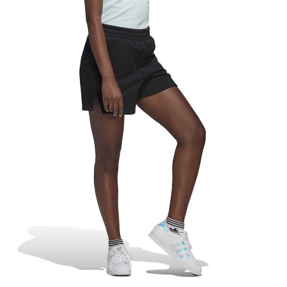 Black adidas Originals shorts side view with draped fabric and curved pocket seam