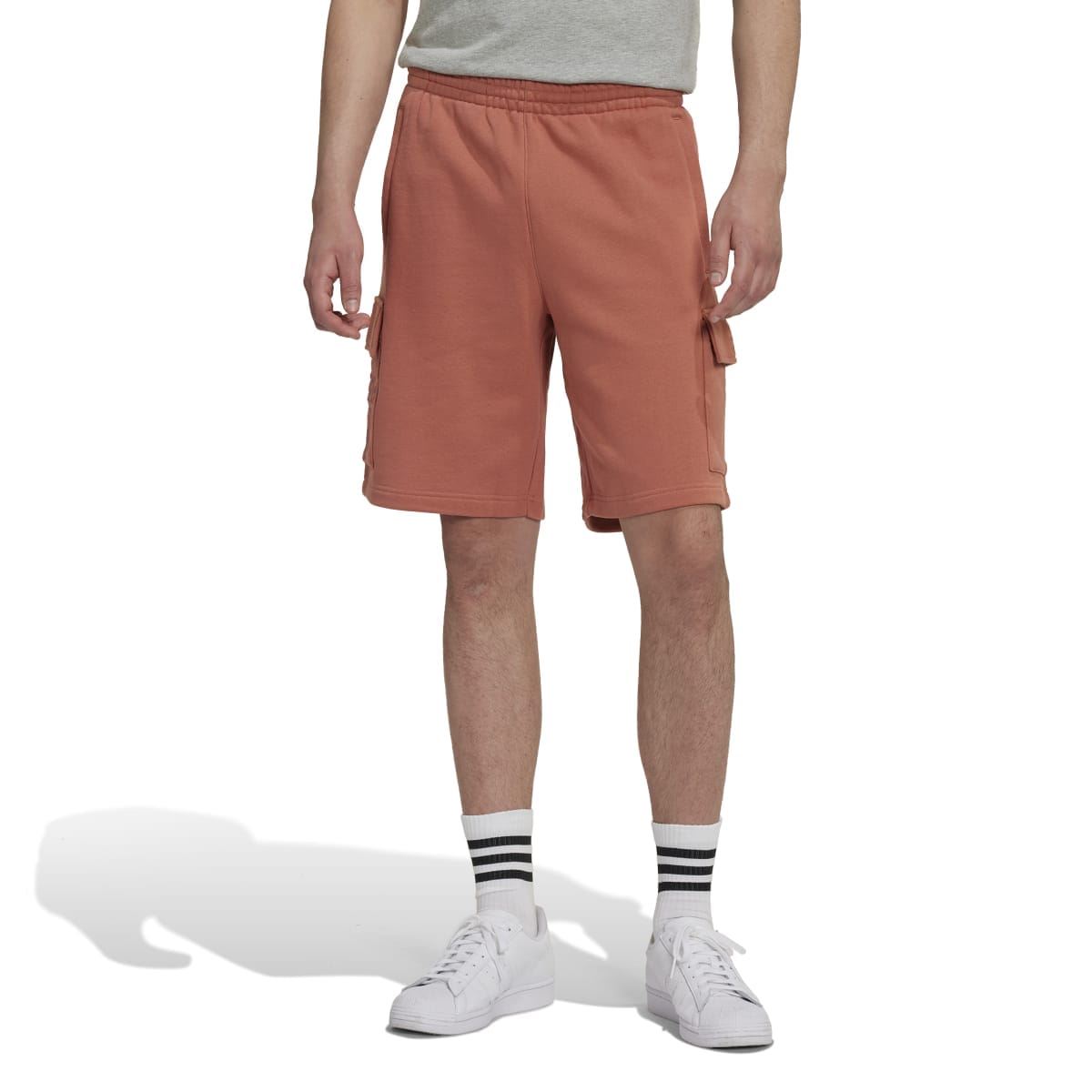 Rust-brown cargo shorts with elastic waistband and side flap pockets, above-knee length