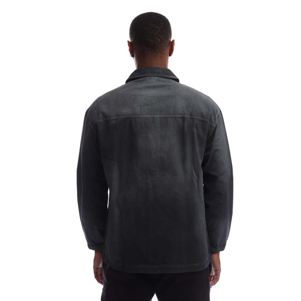 Back view of black coach overshirt with full-length sleeves and button closure