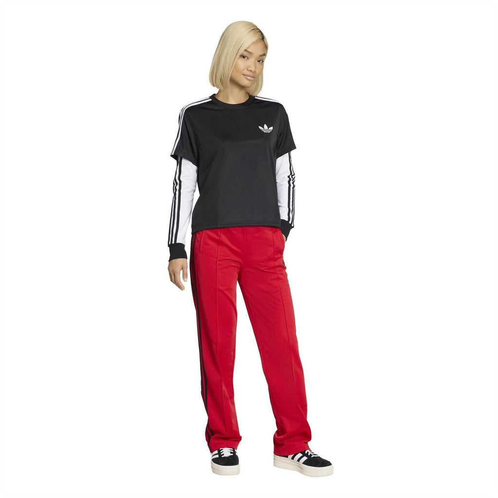 Black adidas Originals Firebird T-shirt with trefoil logo, styled with red track pants