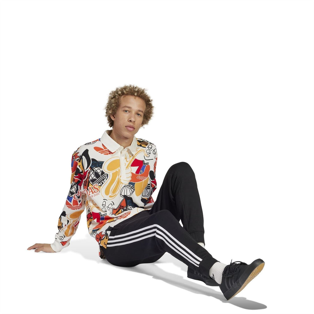 Black slim joggers with white side stripes and ribbed cuffs, relaxed leg pose
