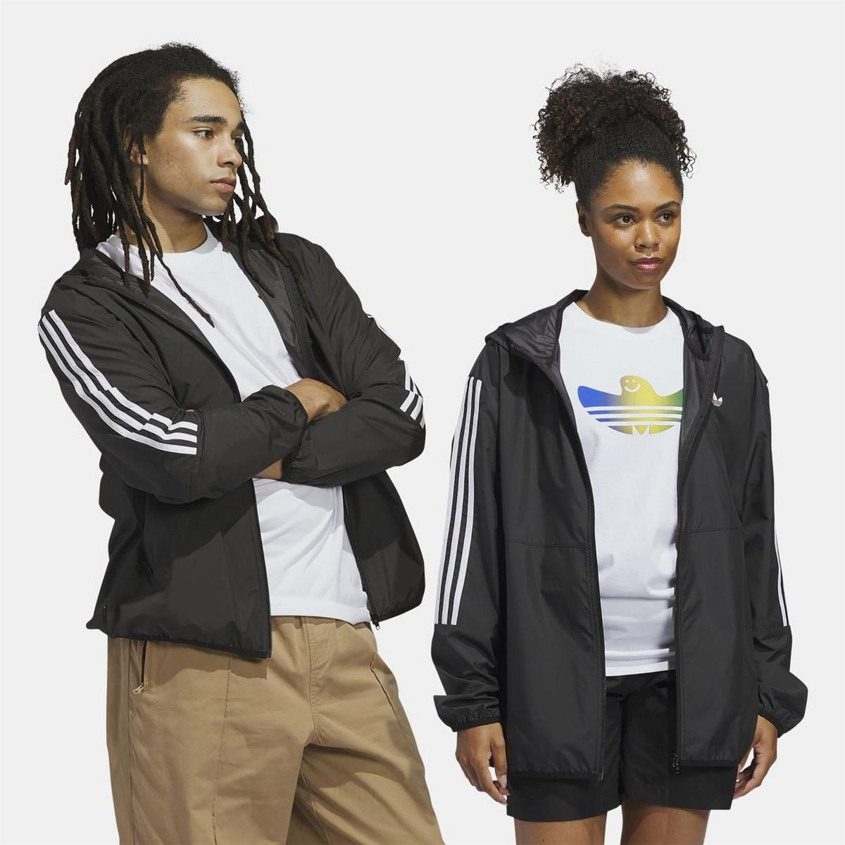 Black windbreaker jacket with hood, front zip, and three white sleeve stripes