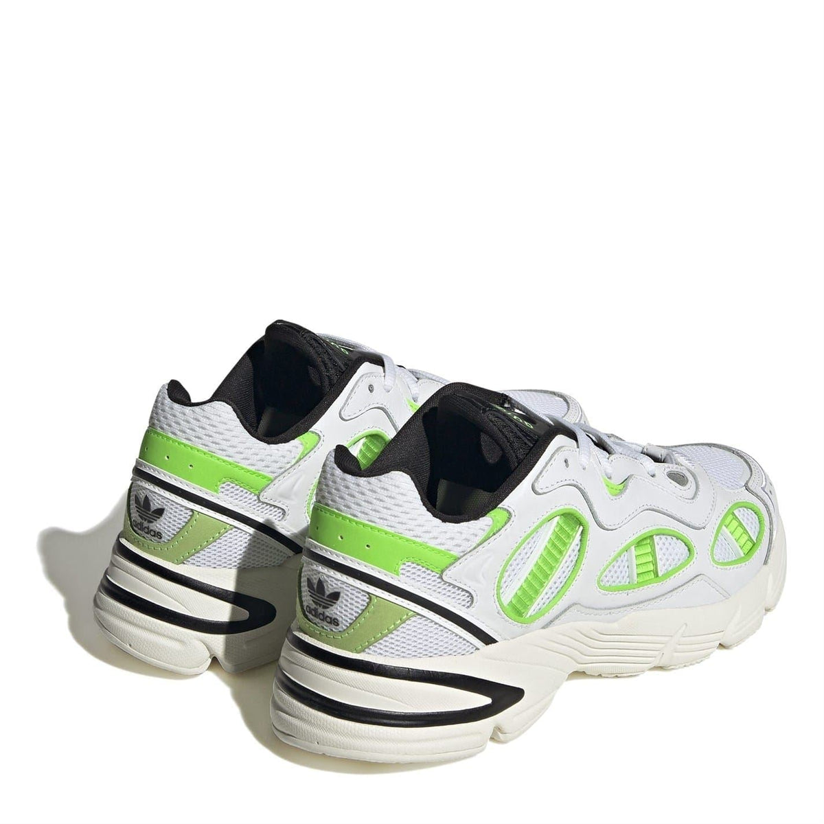 Rear view of white chunky-heel sneakers with neon green stripes and black heel detail