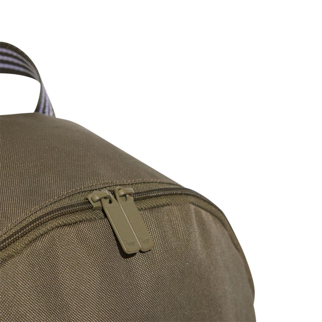 Olive backpack with metal zipper pull on top flap and textured fabric weave