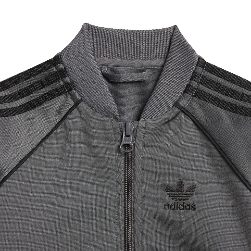 Grey adidas zip-front track jacket for infants with raglan stripes and logo chest graphic