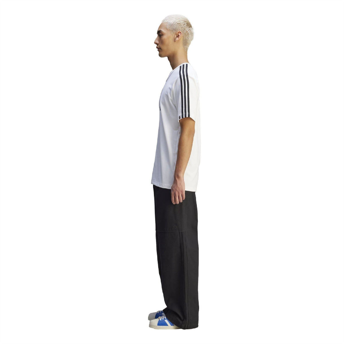 White T-shirt side view on model with black sleeve stripes and short sleeves