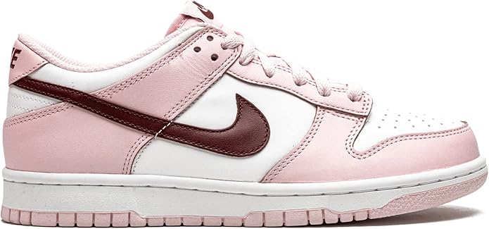 Pink and white low-top sneakers with dark maroon side Swoosh and lace-up