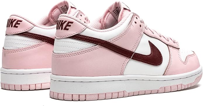 Pink and white low-top sneakers, heel and side view, with dark maroon Swoosh