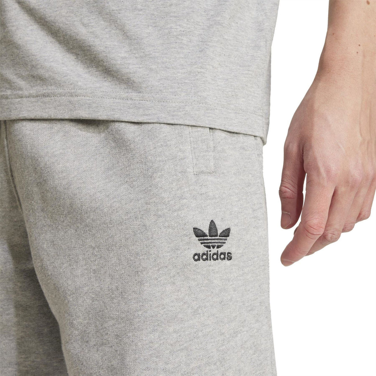 Med Grey Heath adidas Essentials shorts close-up of adidas logo on leg