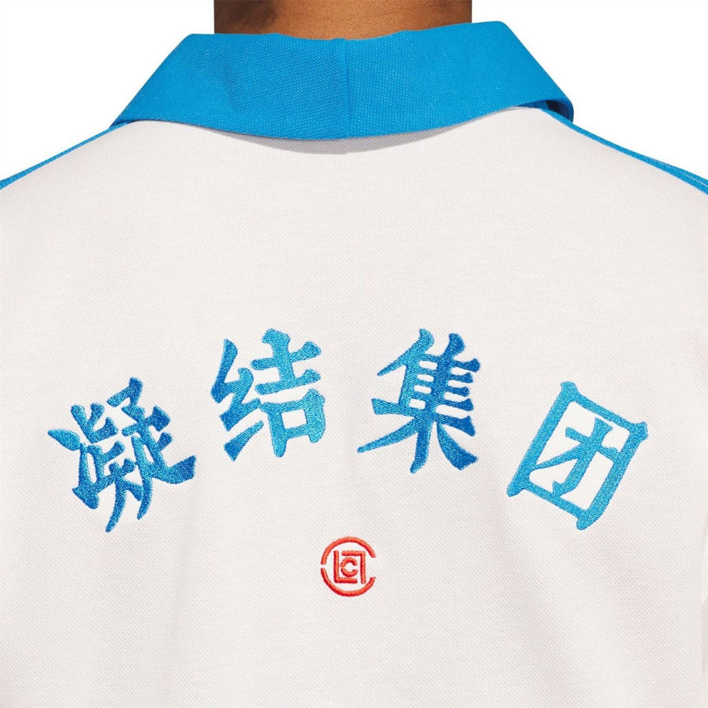 White polo back with blue character print and red emblem, blue shoulder stripes