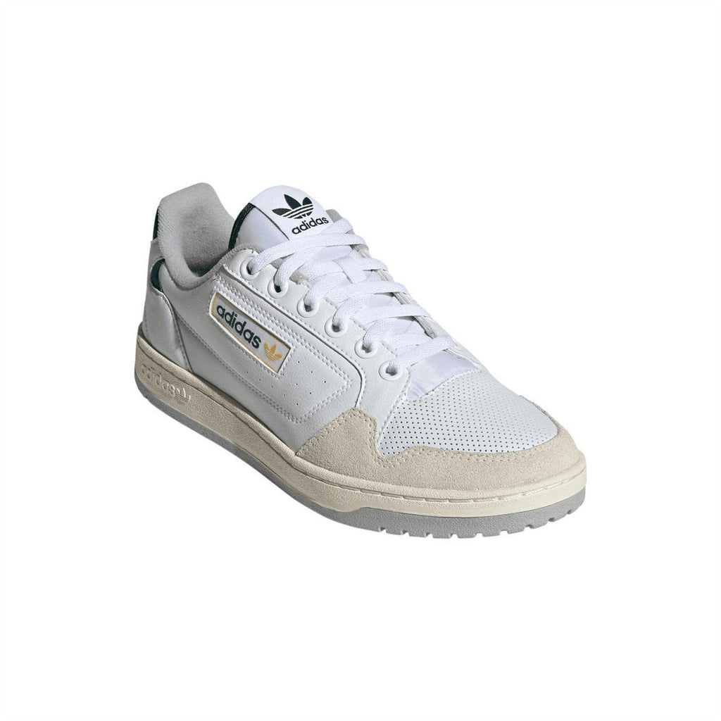 White adidas Originals trainers with tan suede panel, green accents, gold badge and laces